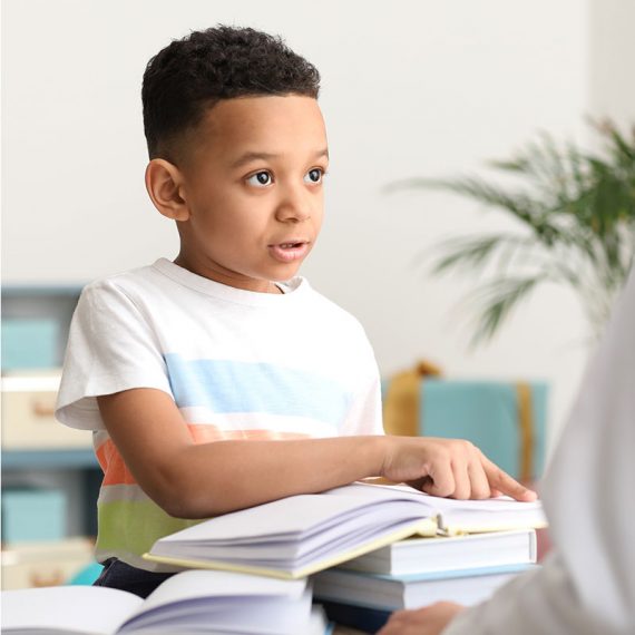 Child reading a book aloud